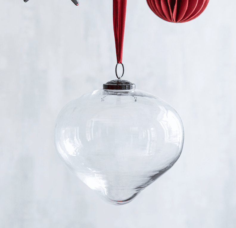 The Hailes Teardrop Bauble, in its large Clear design, is a timeless and elegant ornament. Crafted from recycled glass, it reflects a blend of Clear and Amber tones, perfect for capturing and reflecting festive lights beautifully.